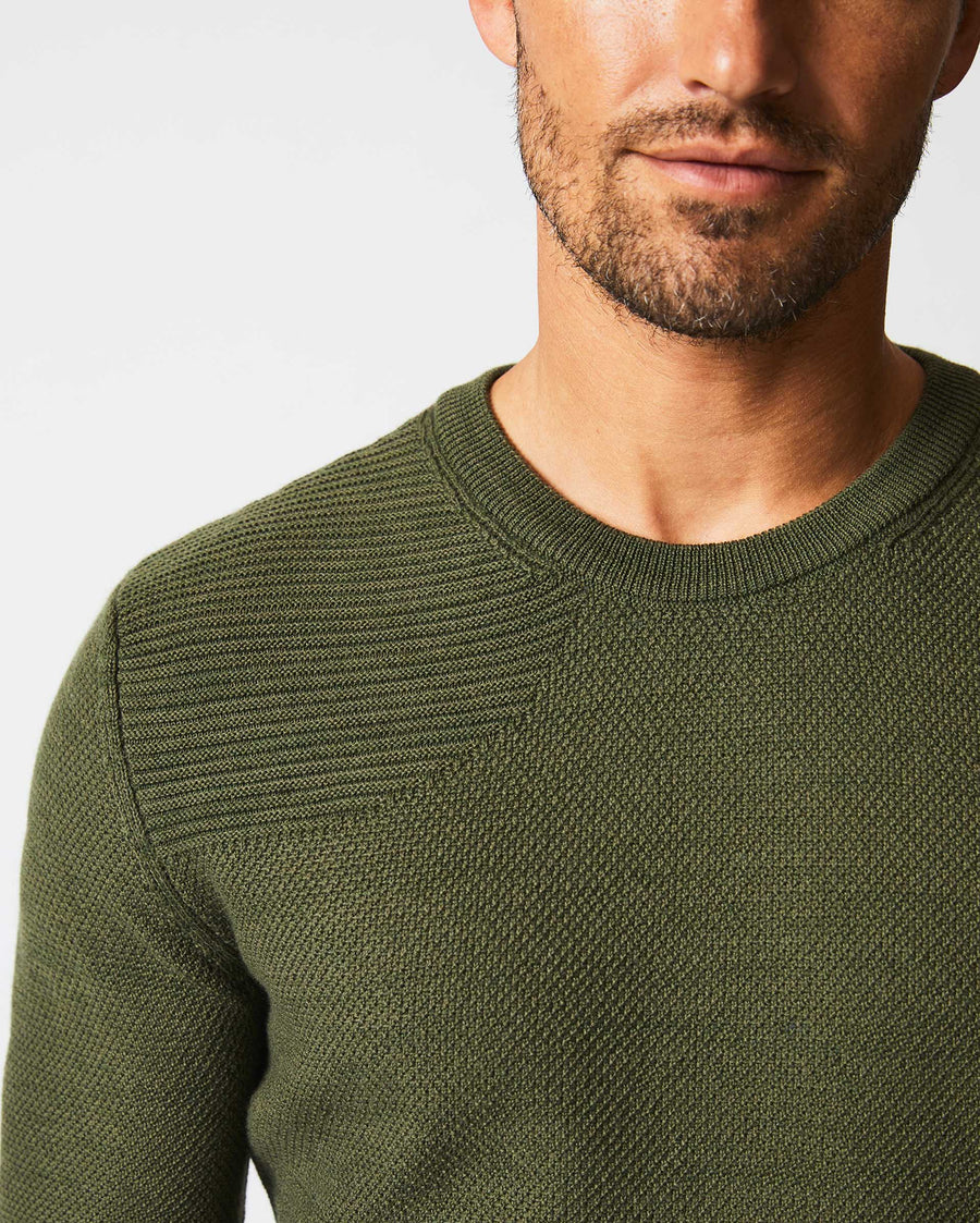 Male model wears the Hunting Sweater in Fern