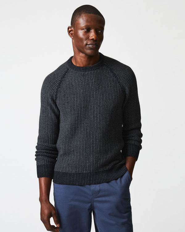 Male model wears the marled crewneck sweater in black