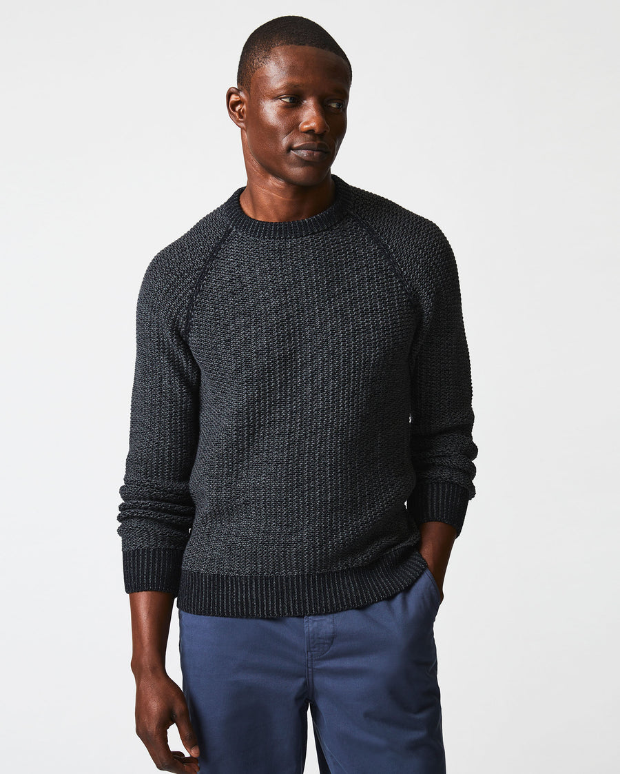 Male model wears the marled crewneck sweater in black