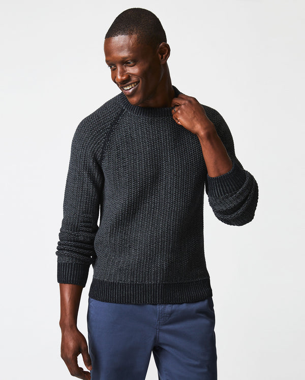 Male model wears the marled crewneck sweater in black