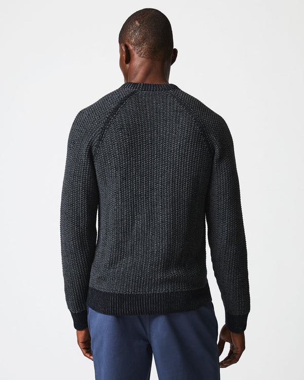 Male model wears the marled crewneck sweater in black