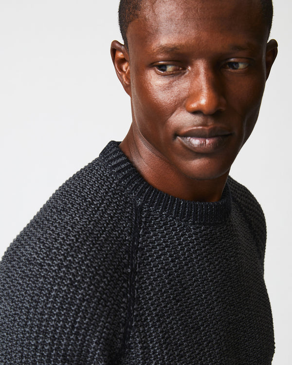 Male model wears the marled crewneck sweater in black