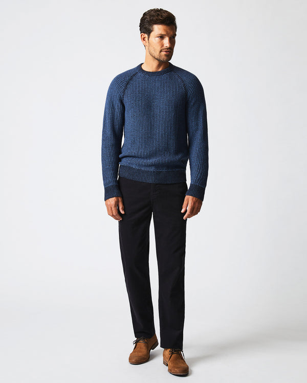 Male model wears the marled crewneck sweater in carbon blue
