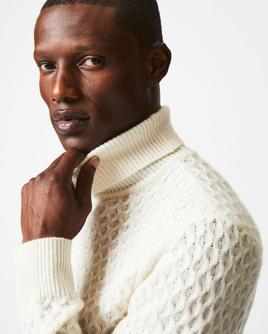 Male model wears the Cashmere Honeycomb Turtleneck in Natural