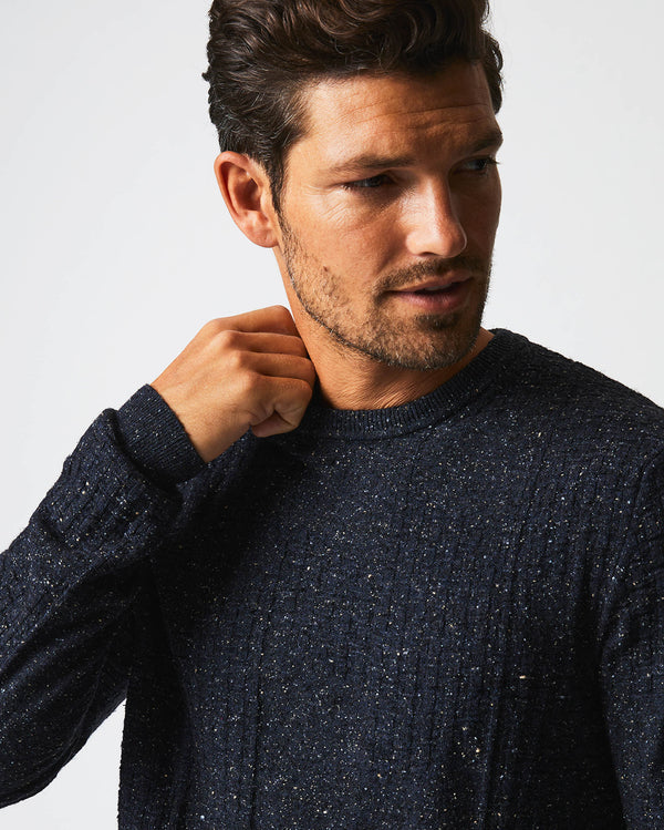 Male model wears the Weave Sweater Crew in Navy Marled
