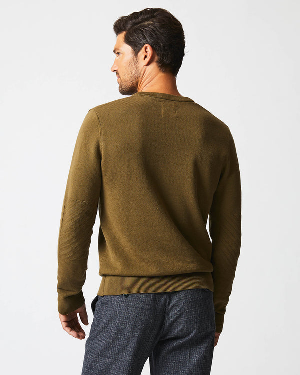 Male model wears the American V Neck Sweater in Olive