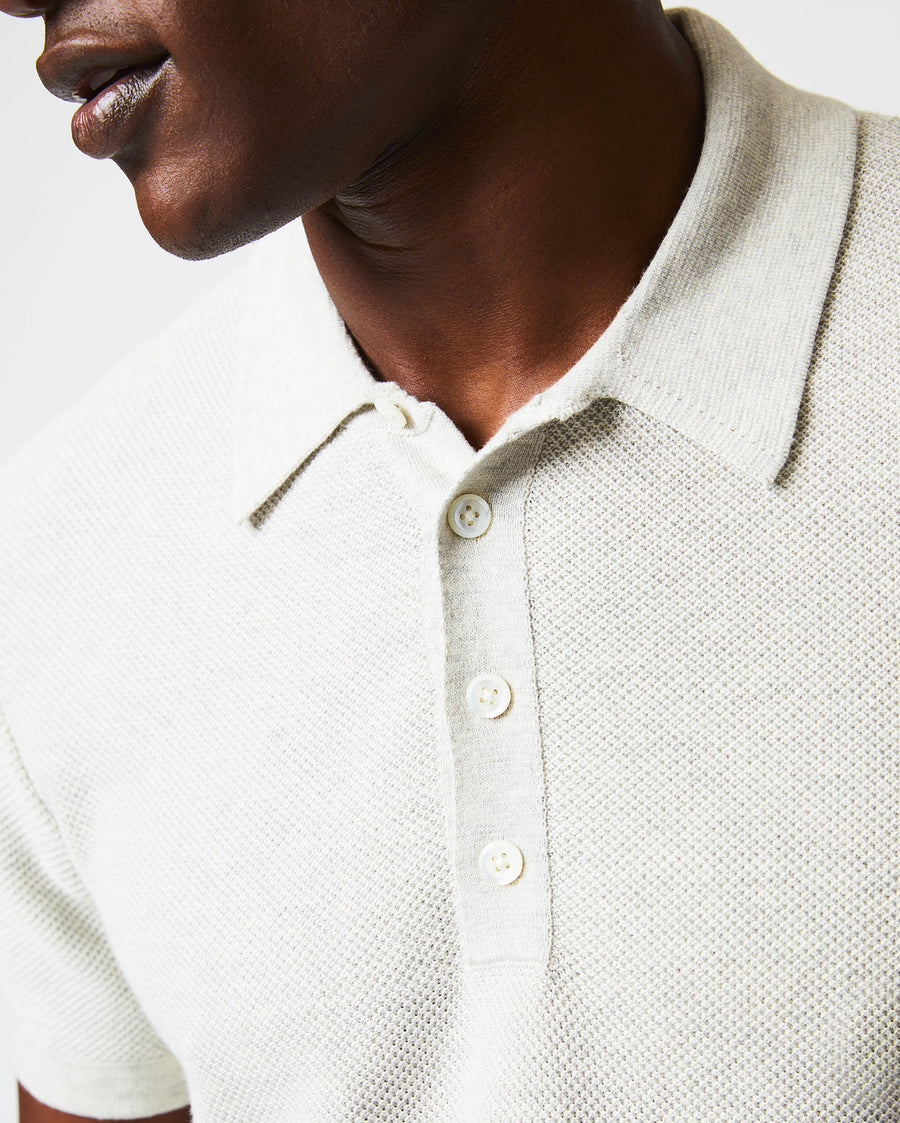 Male model wears the American Pique Sweater Polo in Heathered Grey