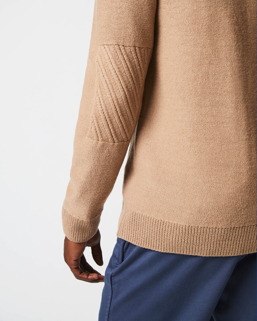 Male model wears the Collegiate Cardigan in Camel/Heather