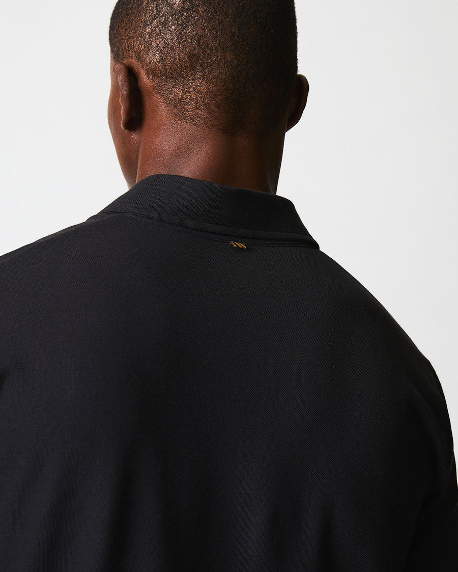 Male model wears the Pique Pensacola Polo in Black