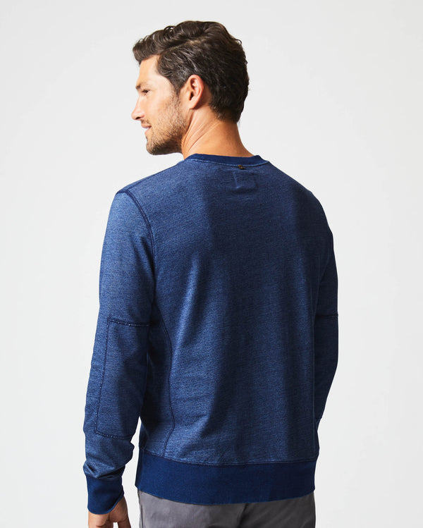 Male model wears the Indigo Terry Sweatshirt in Dark Indigo | Elbows patches