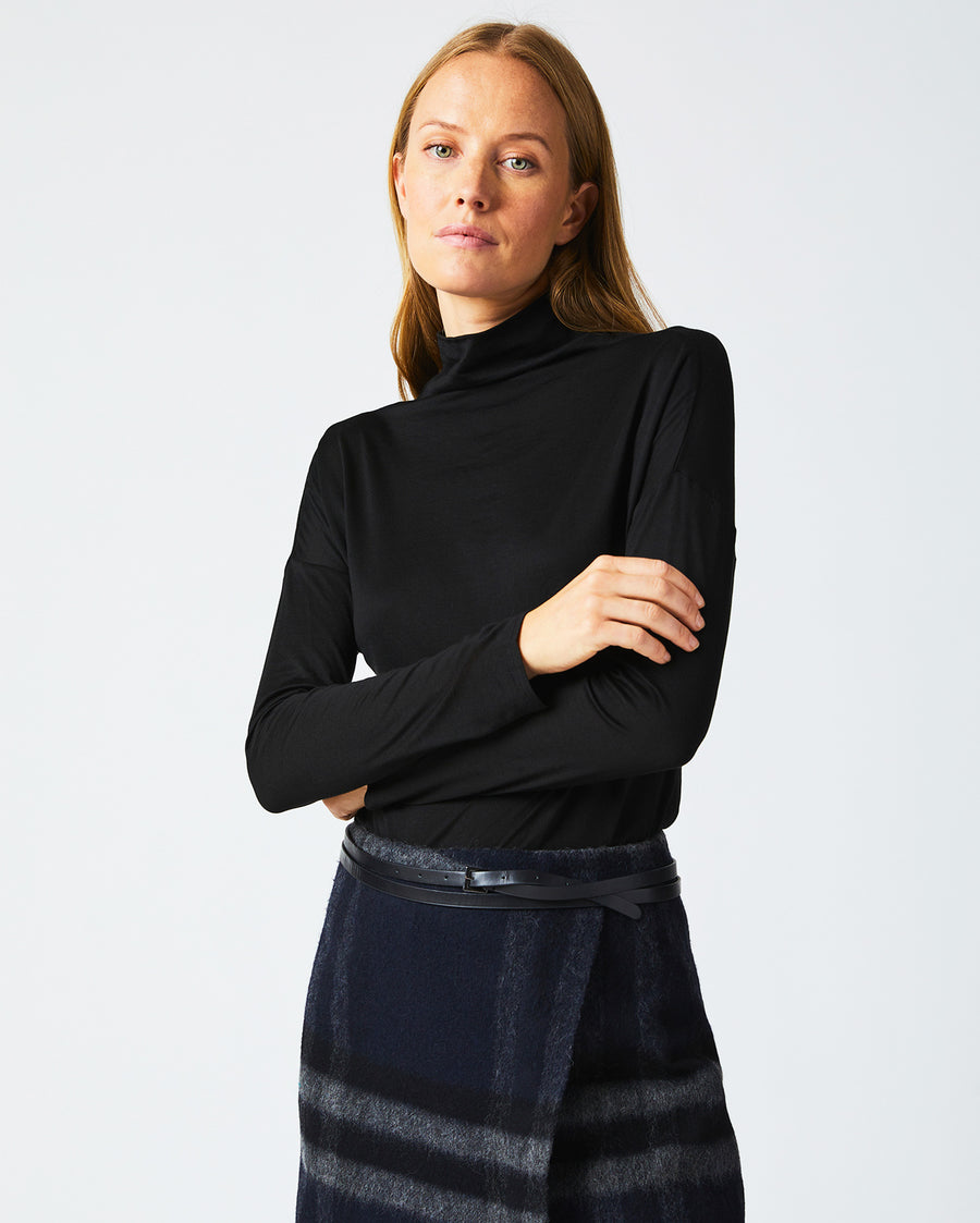 Female model wears the Funnel Neck Knit in Black