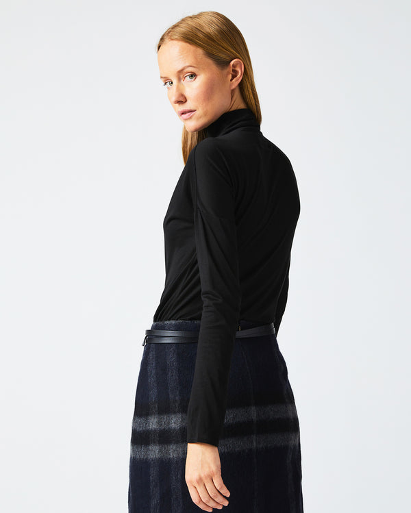 Female model wears the Funnel Neck Knit in Black