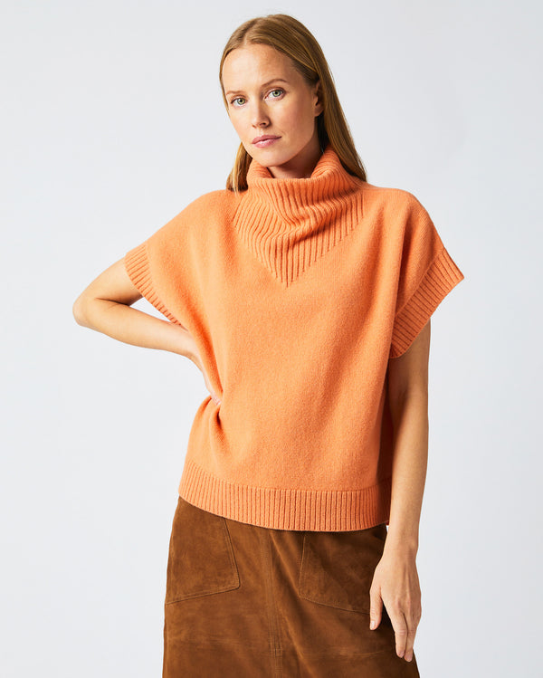 Female model wears the Funnel Shell Sweater in Ember.