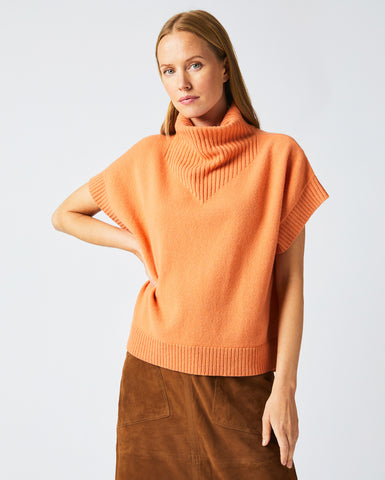 Female model wears the Funnel Shell Sweater in Ember.