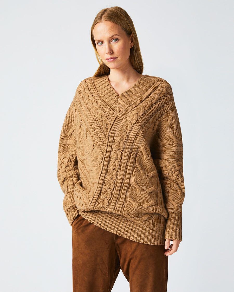 Female model wears the Bias Cable Sweater in Camel