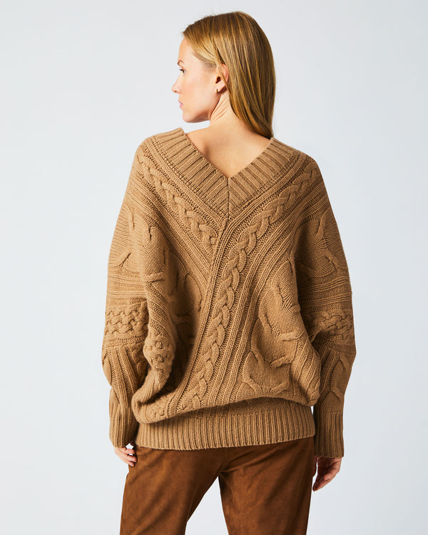 Female model wears the Bias Cable Sweater in Camel