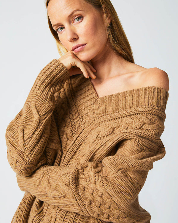 Female model wears the Bias Cable Sweater in Camel