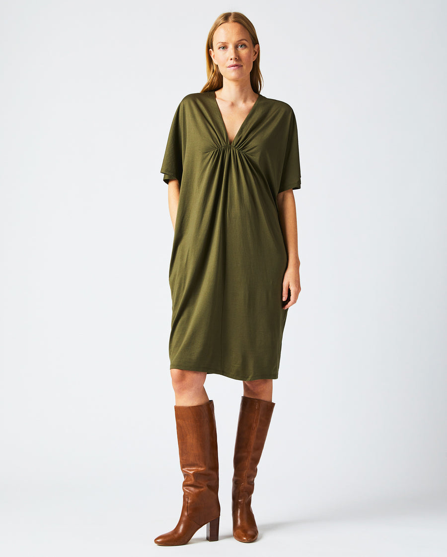 Female model wears the Cocoon Knit Dress in Dark Green