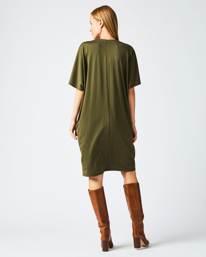 Female model wears the Cocoon Knit Dress in Dark Green