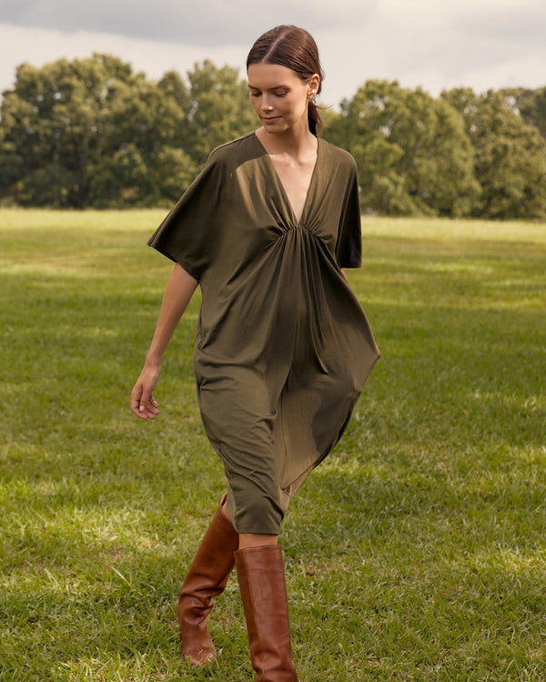 Female model wears the Cocoon Knit Dress in Dark Green