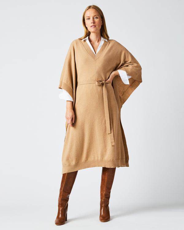Female model wears the Poncho Sweater Dress in Camel