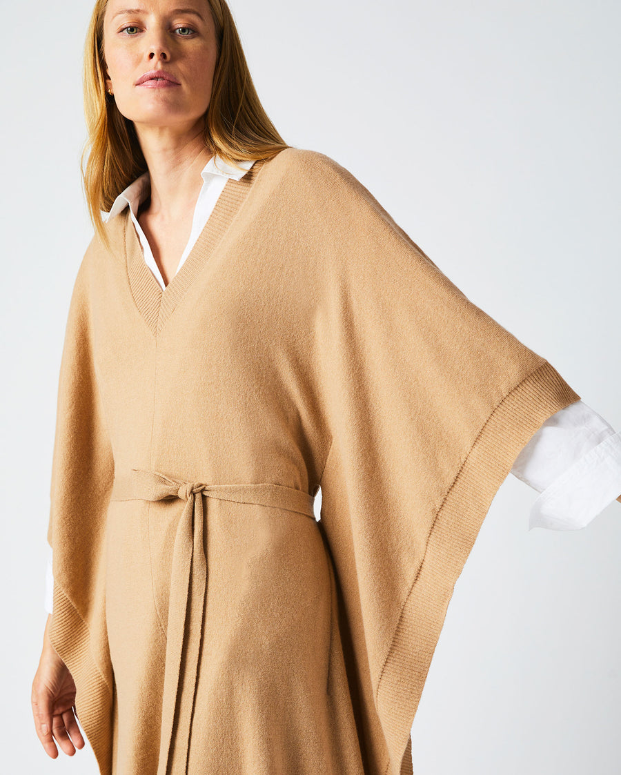 Female model wears the Poncho Sweater Dress in Camel