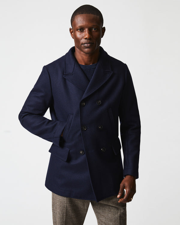 Male model wears the Bond Peacoat in Navy