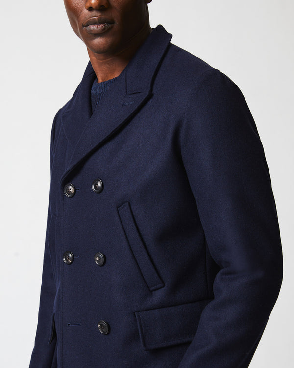 Male model wears the Bond Peacoat in Navy