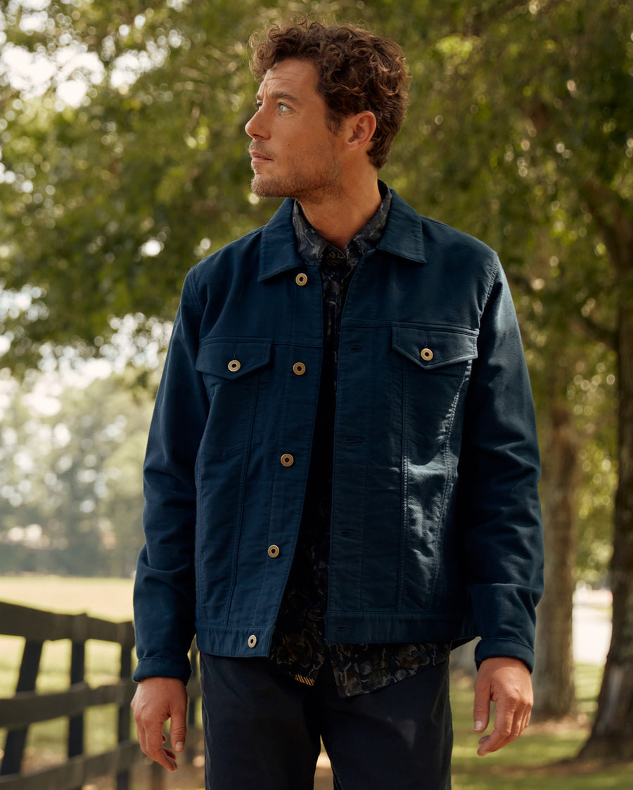 Male model wears the Moleskin Tupelo Trucker Jacket in Carbon Blue