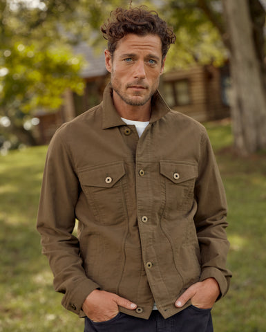 Male model wears the Moleskin Tupelo Trucker Jacket in Olive