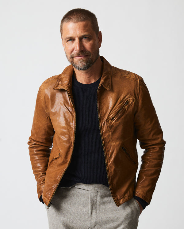 Male model wears the Blake Jacket in Saddle