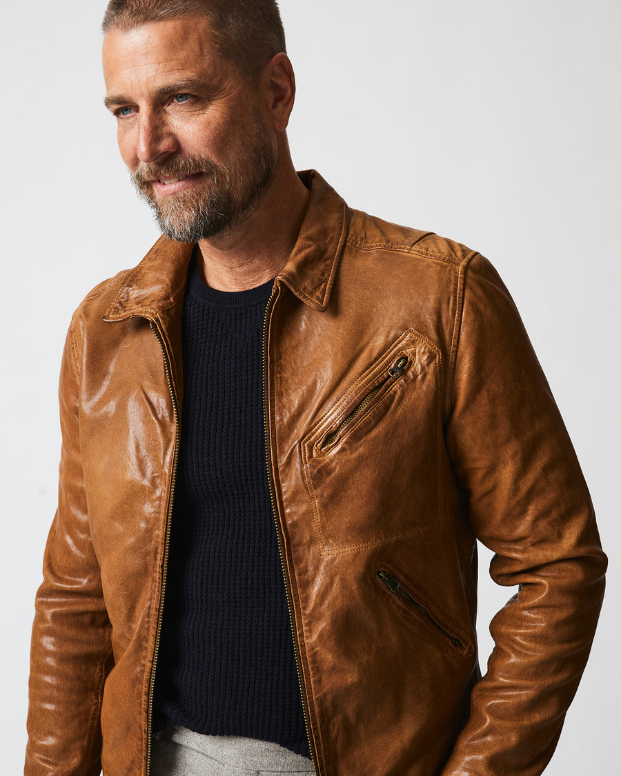 Male model wears the Blake Jacket in Saddle