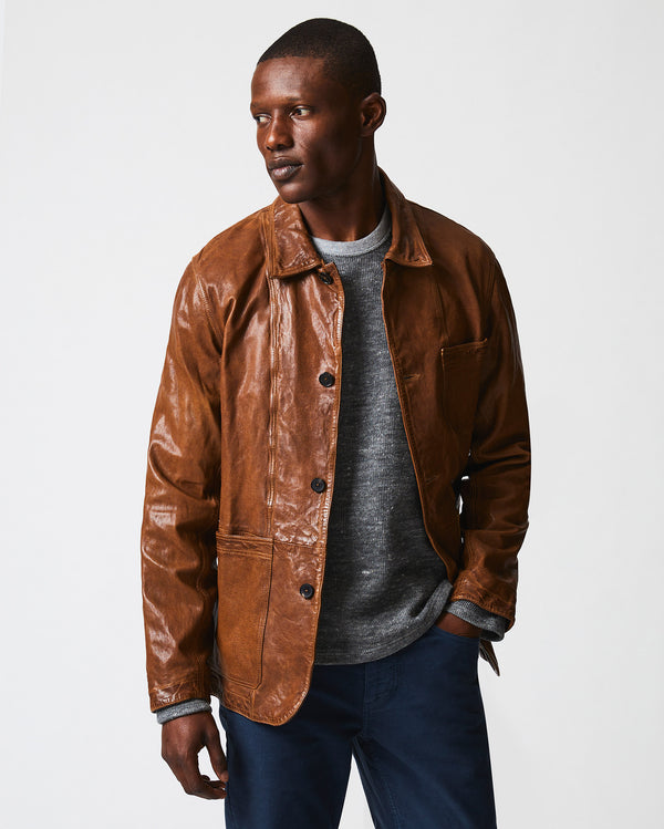 Male model wears the Leather Chore Coat in Cognac