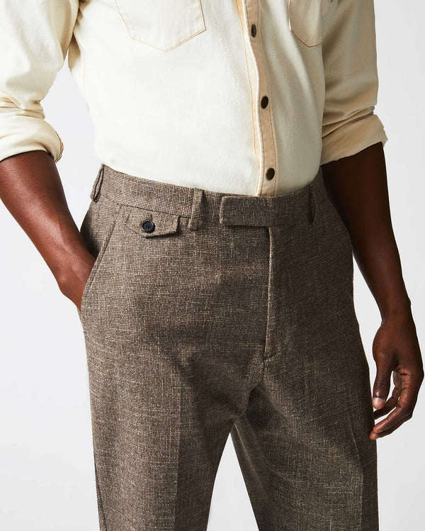 Male model wears the Flat Front Trouser in Black/Brown