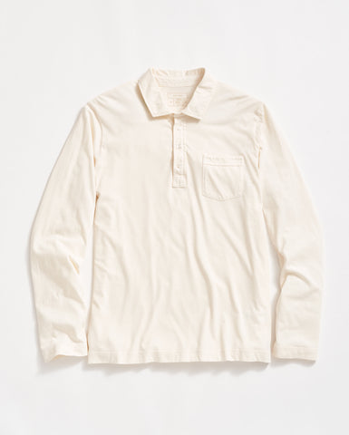 A long-sleeve, off-white collared shirt with a front pocket on the left chest and a partial button placket, laid flat on a white background.