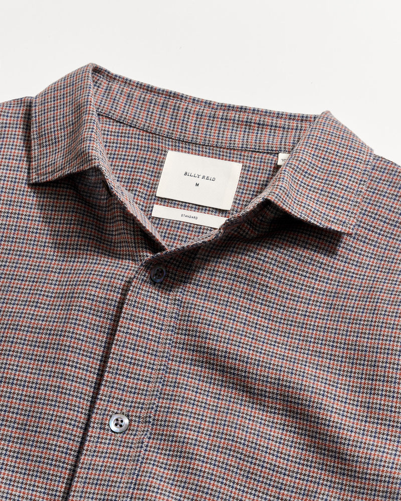 Checkered shirt with a visible brand label on a light gray background Alternate