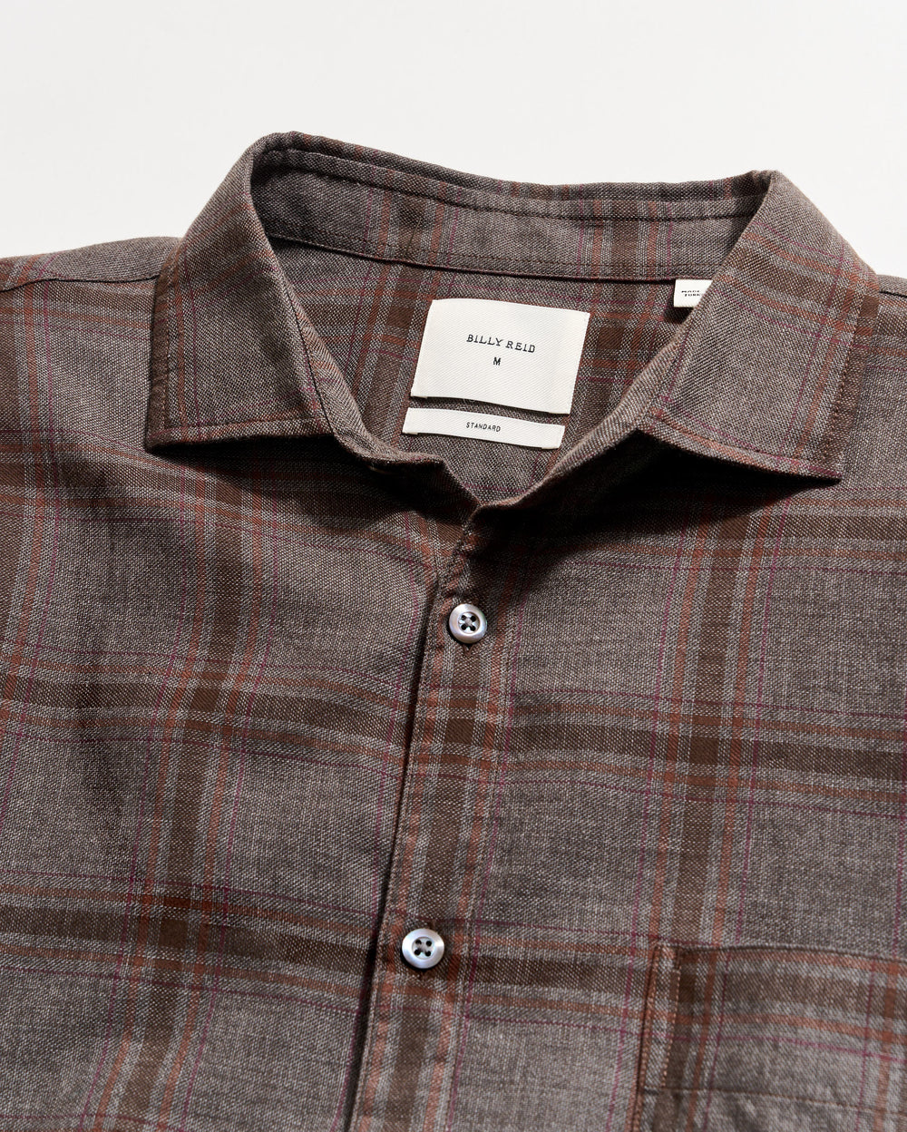 Plaid shirt with a collar and buttons on a light gray background