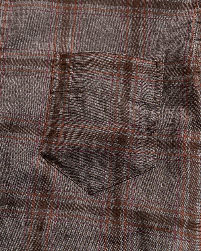 Close-up of a plaid fabric with brown and gray pattern
