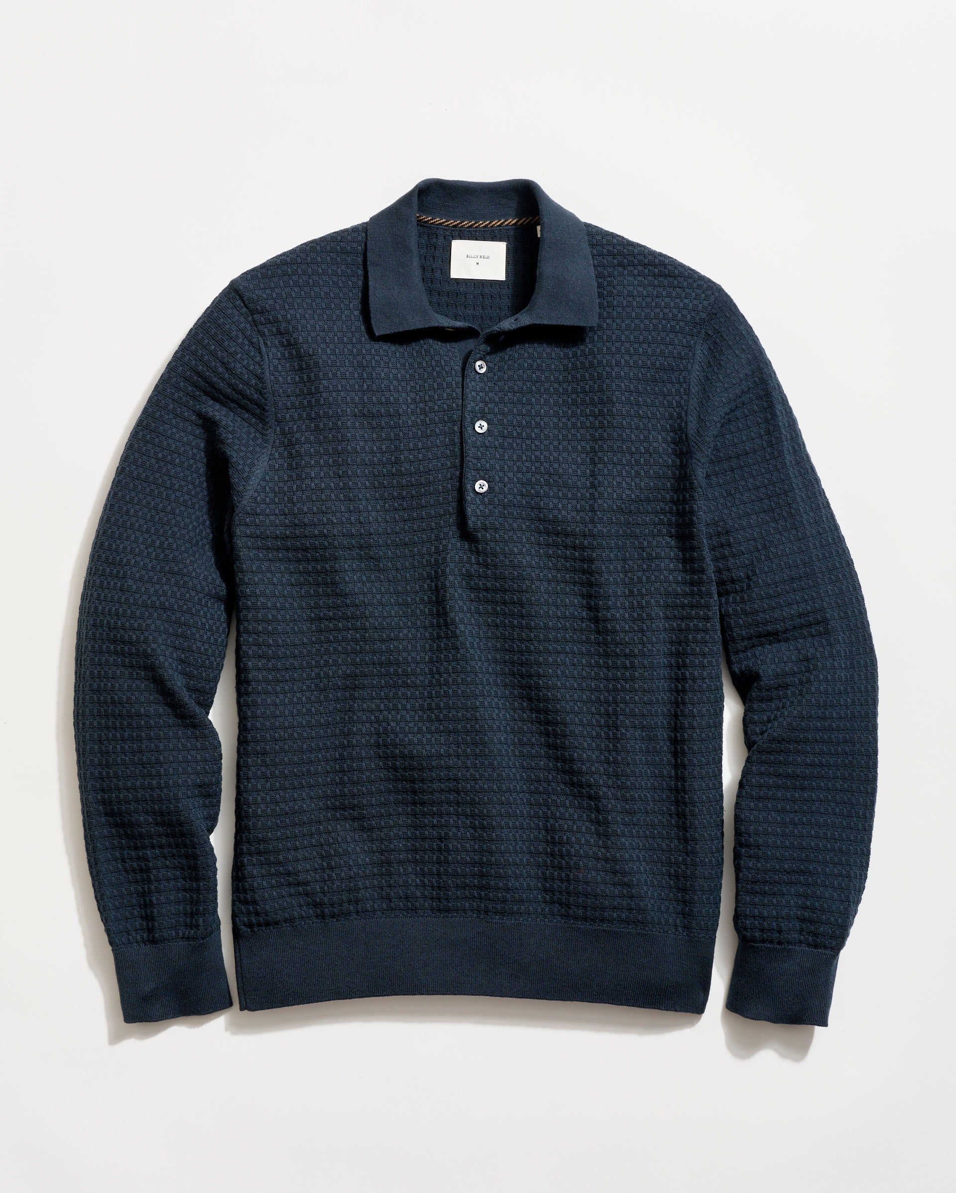 Dark blue textured sweater on a light background