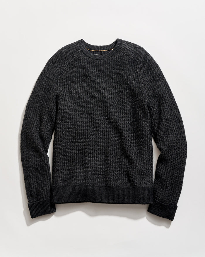 Dark gray sweater on a light gray background