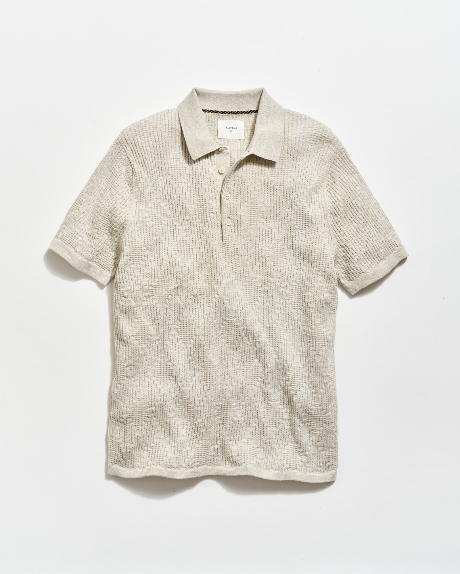 Beige short-sleeve polo shirt on a white background
