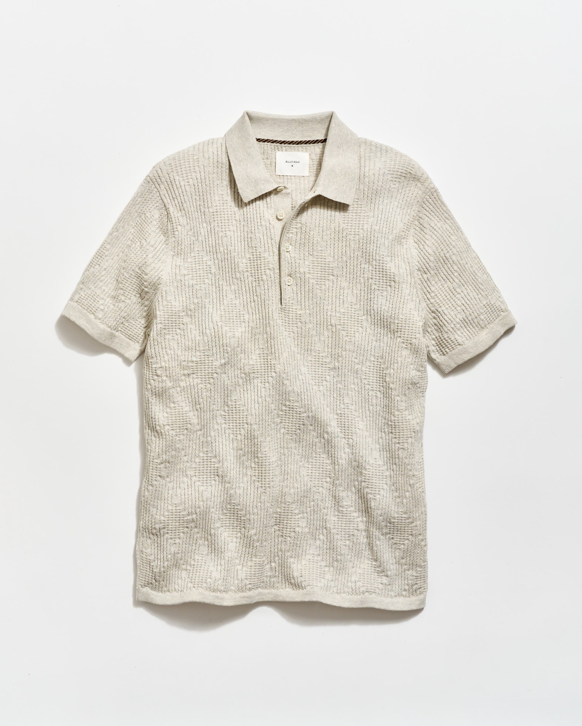 Beige short-sleeve polo shirt on a white background