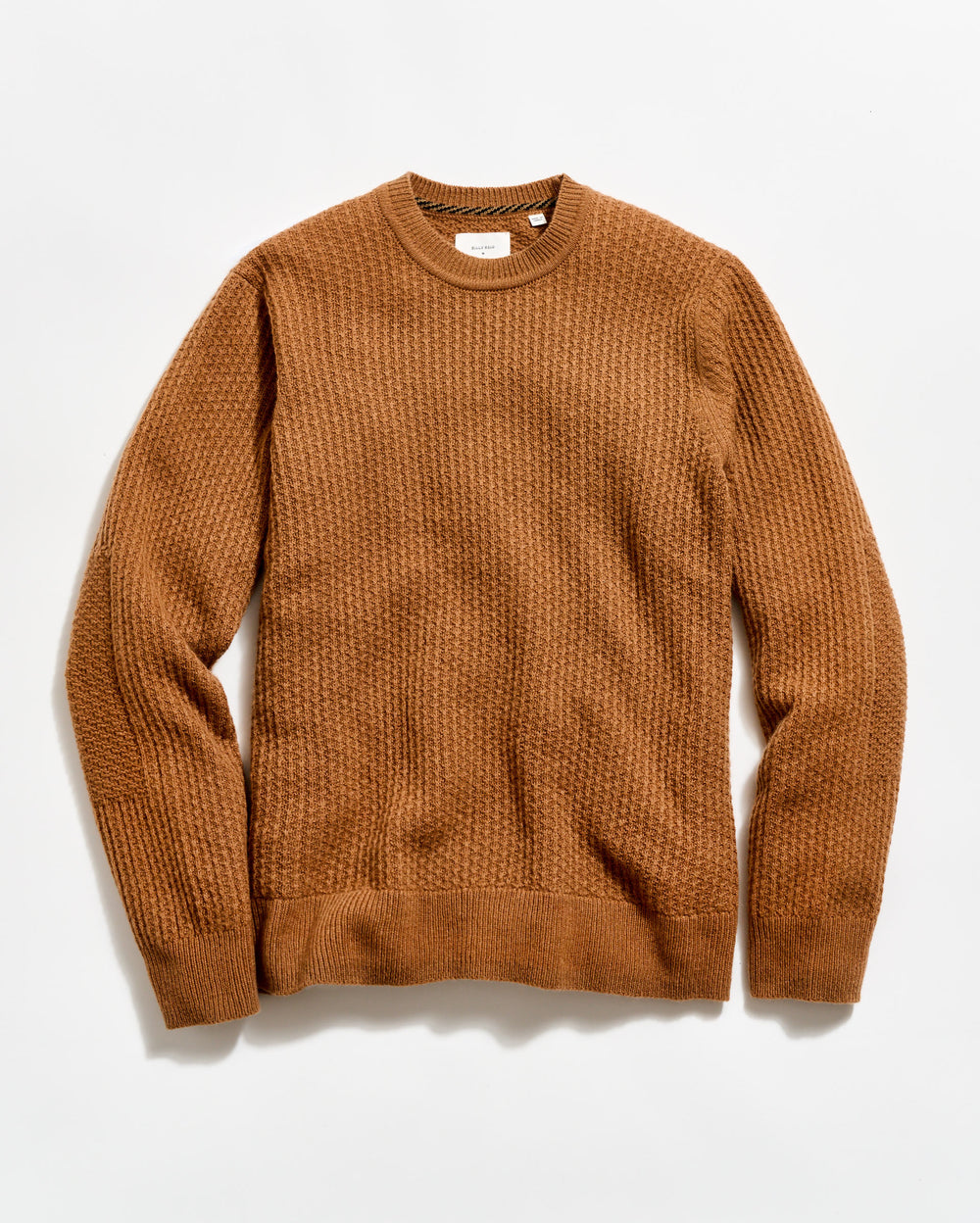 Brown sweater on a light beige background