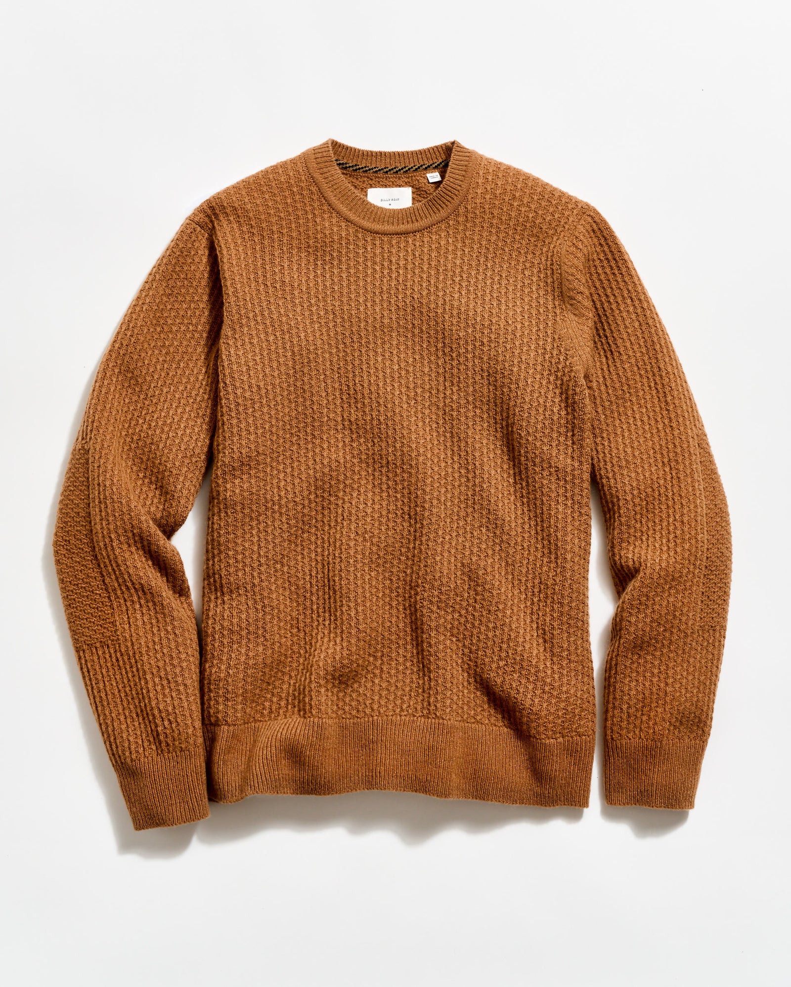 Brown sweater on a light beige background