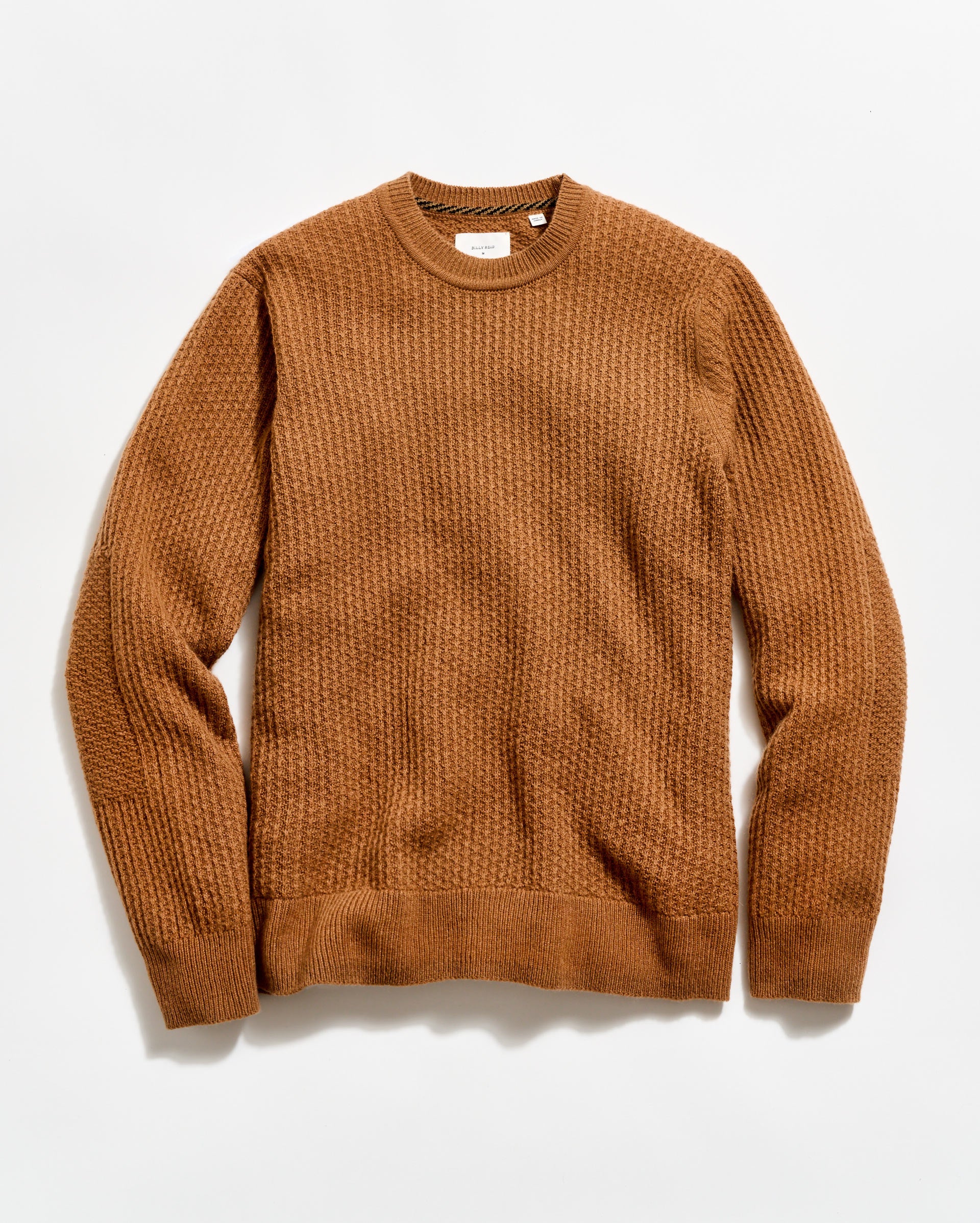 Brown sweater on a light beige background