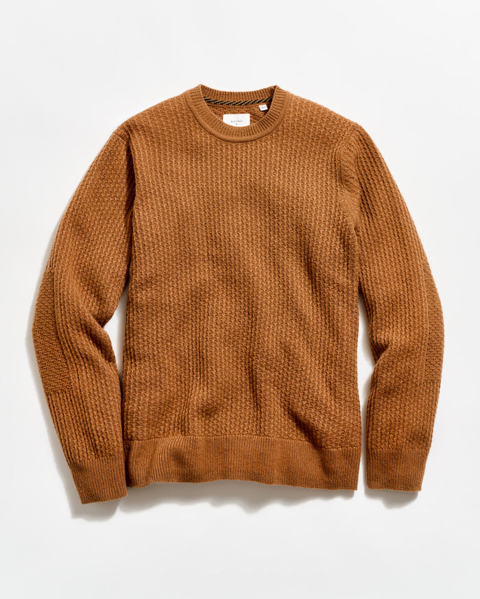 Brown sweater on a light beige background