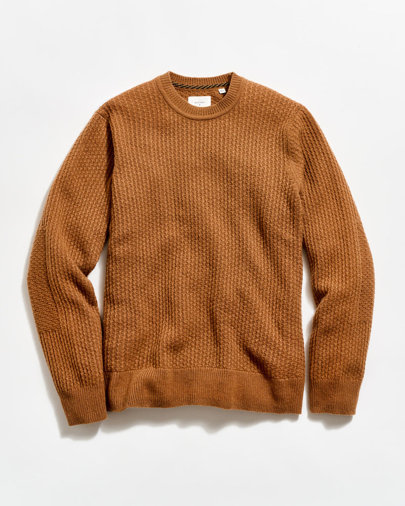 Brown sweater on a light beige background