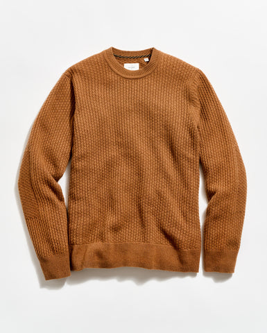 Brown sweater on a light beige background