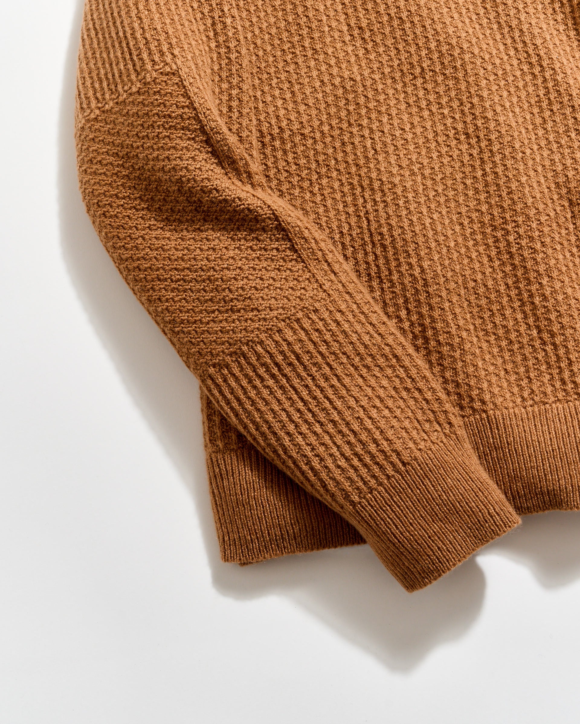 Brown knitted sweater on a white background