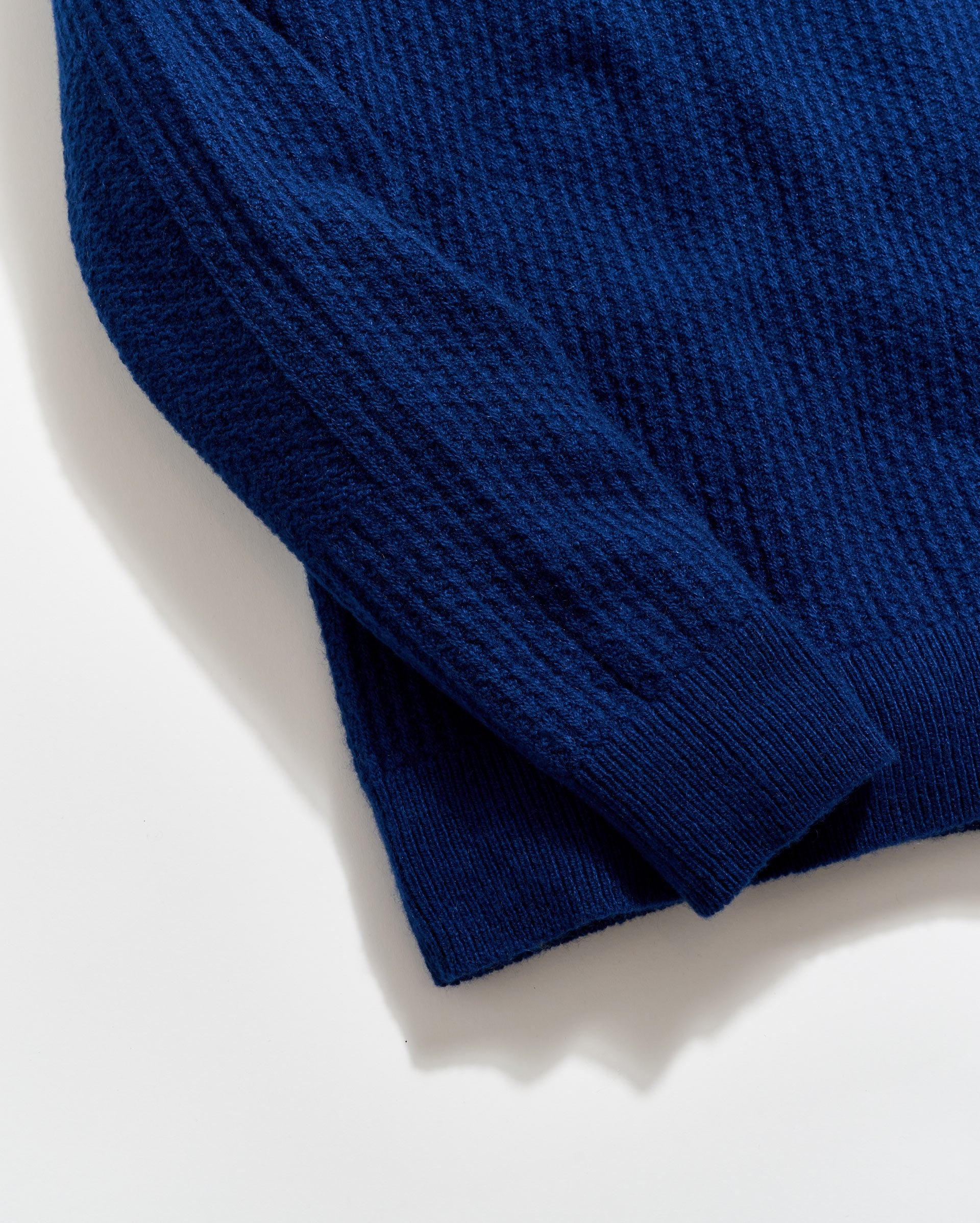 Close-up of a blue sweater on a light background